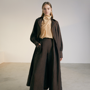 The front of a model wearing a brown colored Long Coat