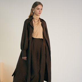 The front of a model wearing a brown colored Long Coat